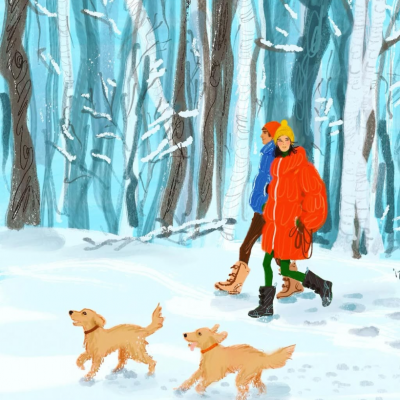 冬の森の中を散歩する犬を連れたカップル